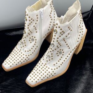 This is a Jeffrey Campbell Show Pony Embellished Boot in white leather